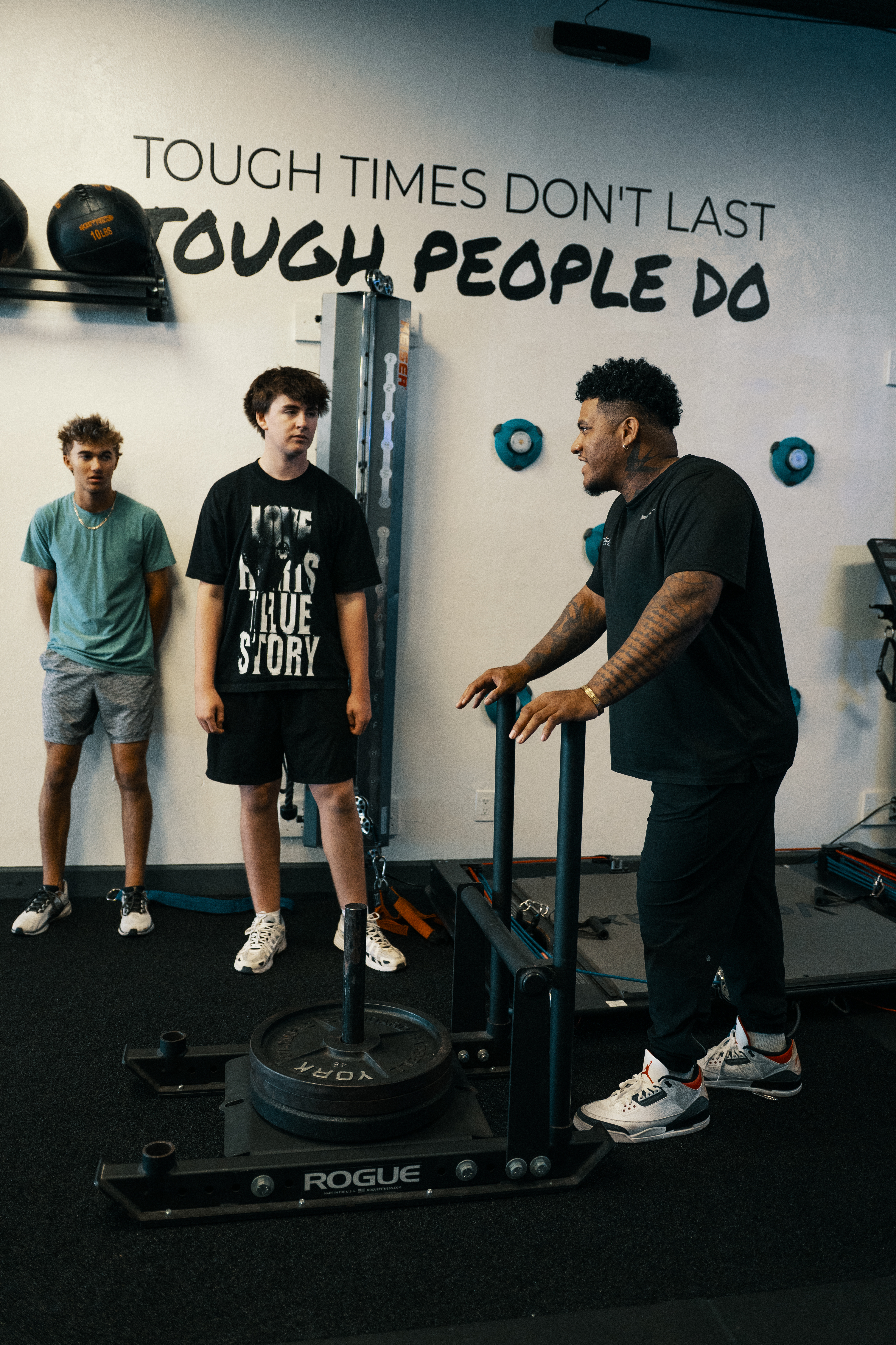 Teen athletes learning sled training with a Stealth Performance youth coach in Phoenix