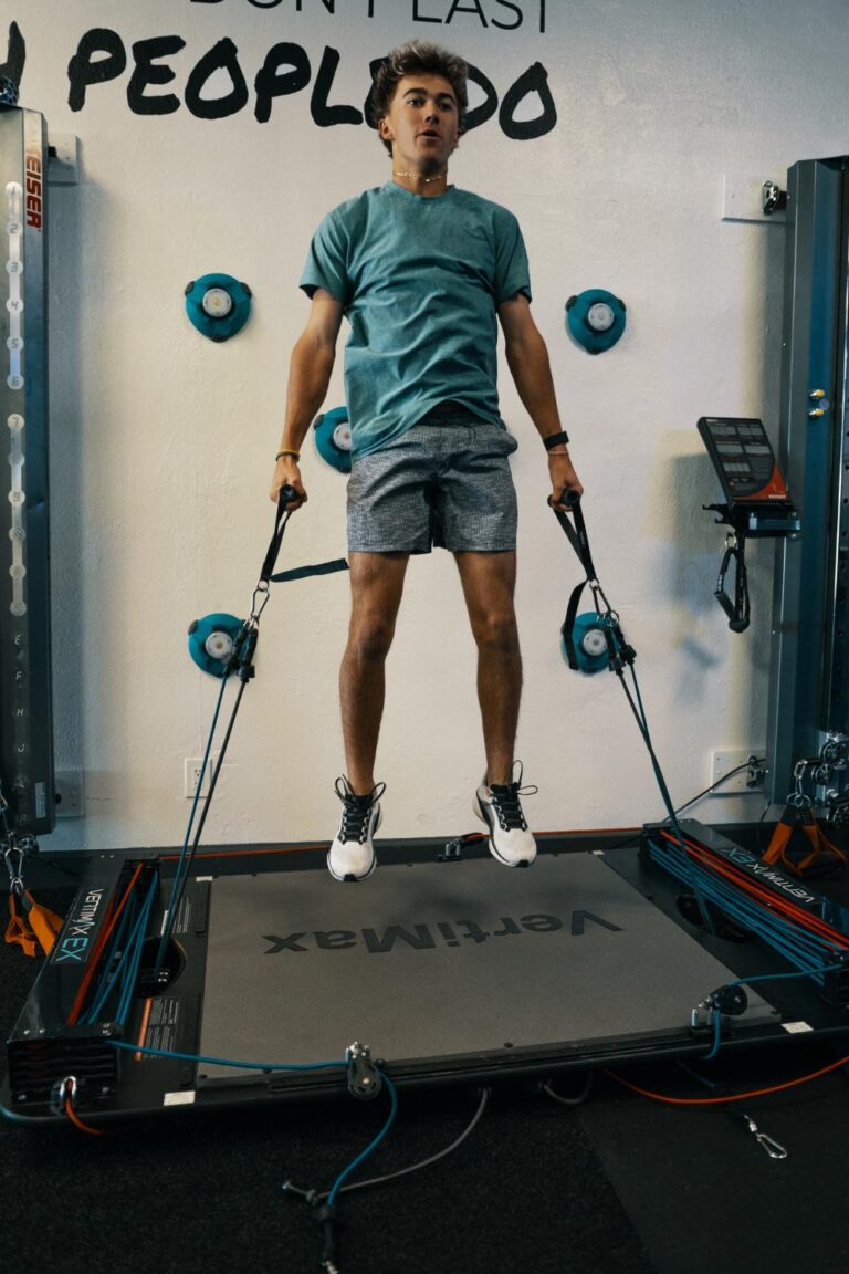 Young athlete doing a resisted jump drill in youth performance training in Phoenix