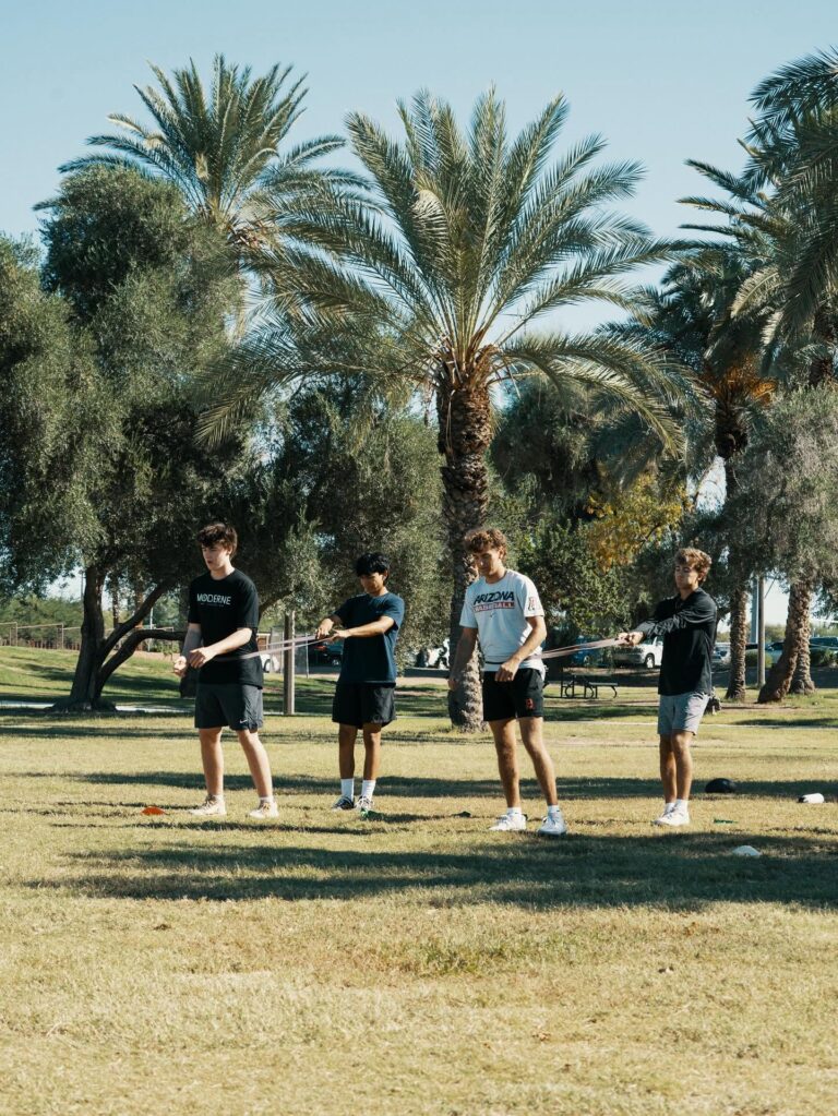 High school athletes doing a band warm-up before speed training in Phoenix