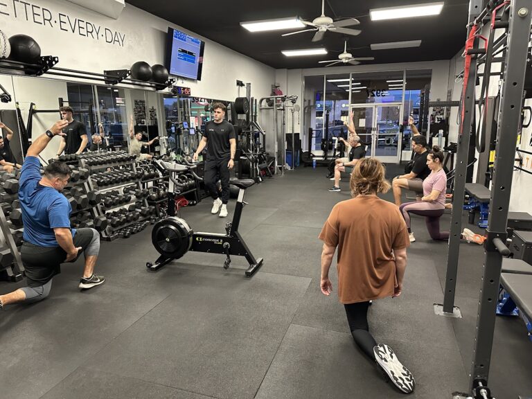 Coach working the floor during a semi-private training session at Stealth Performance in Phoenix