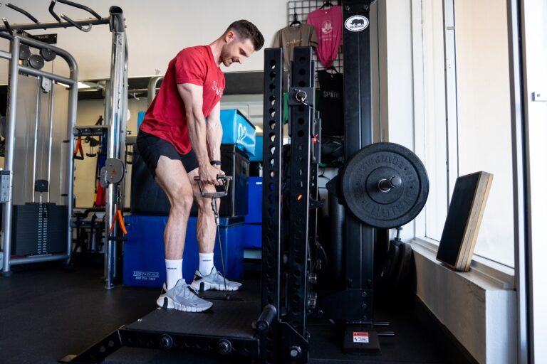 High school athlete learning trap bar deadlift form in youth strength training, Phoenix