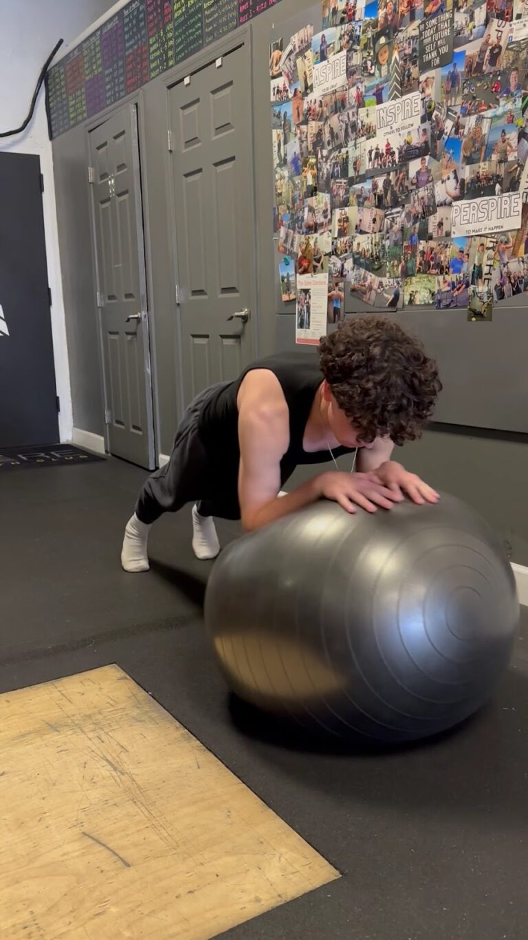 Teen athlete doing core and balance work on a stability ball at Stealth Performance